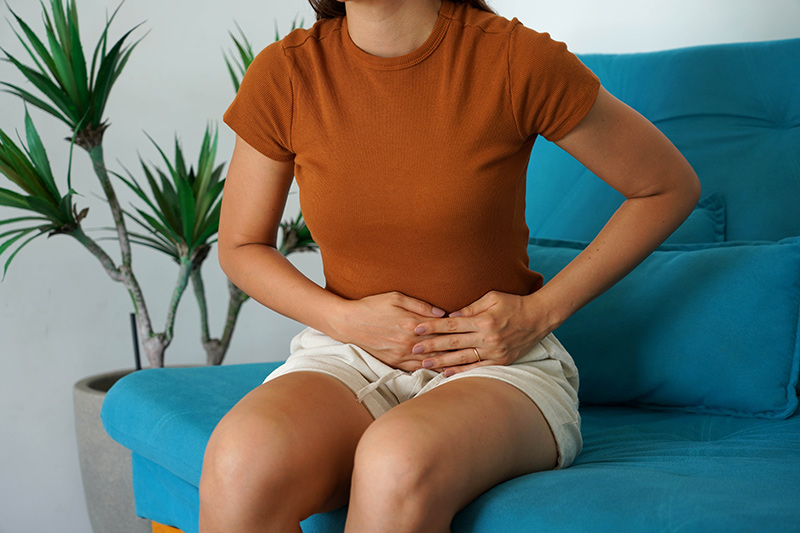 Woman experiencing abdominal pain from ovarian cyst symptoms
